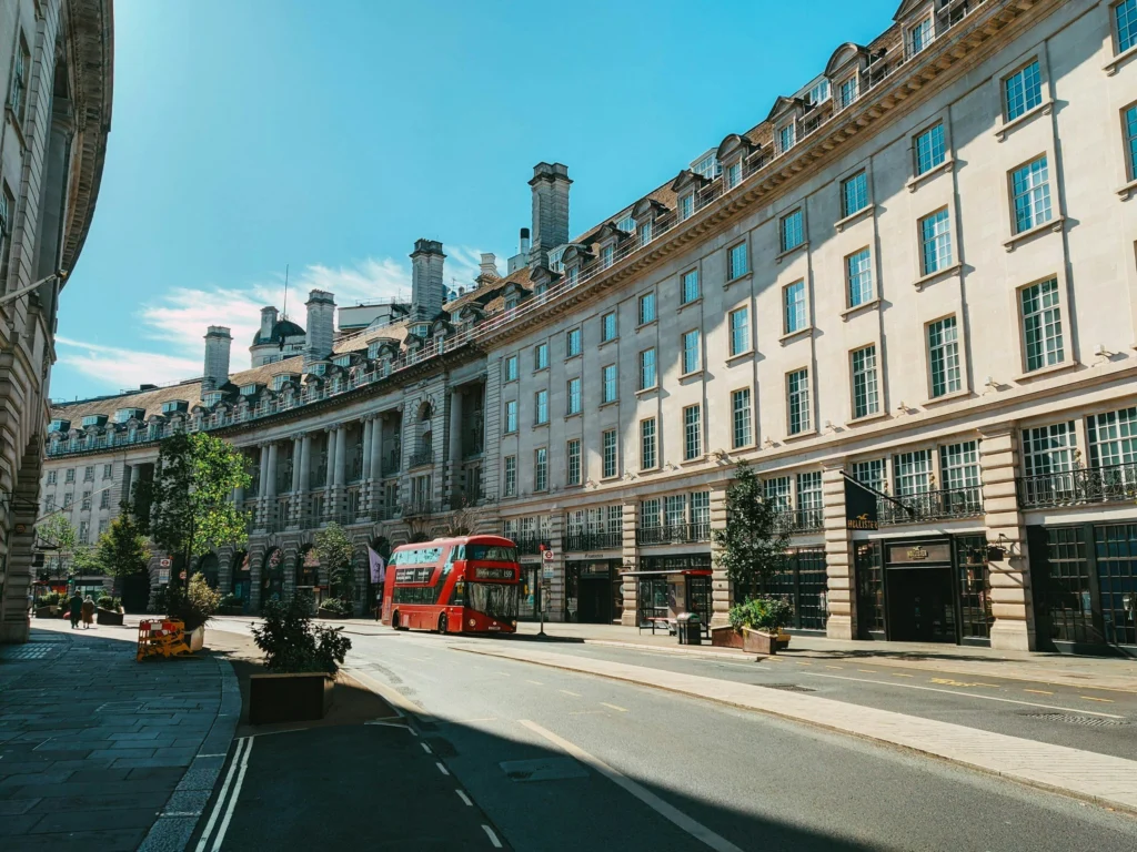 A red London bus on Regent Street on a sunny day