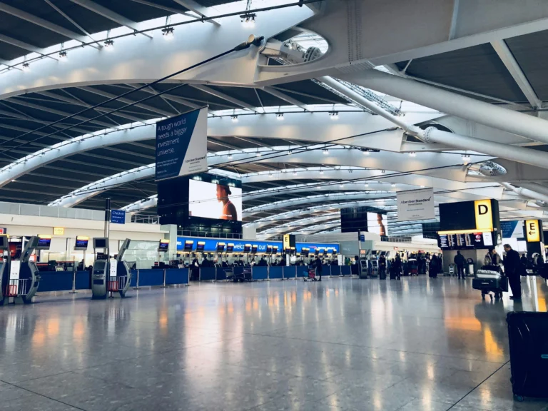 Check-in desks under the curved roof of a bright departures hall